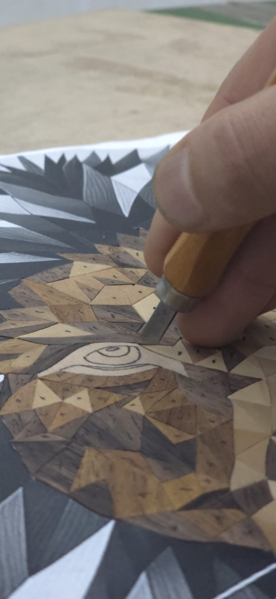 Artist reviewing the work under studio lighting